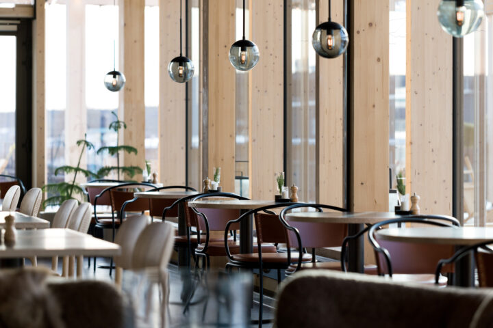Dining area at Restaurant Mandel inside The Wood Hotel by Elite, with timber columns and pendant lights.