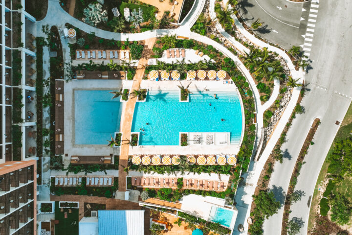 Hotel Indigo Grand Cayman and its pool deck viewed from above.